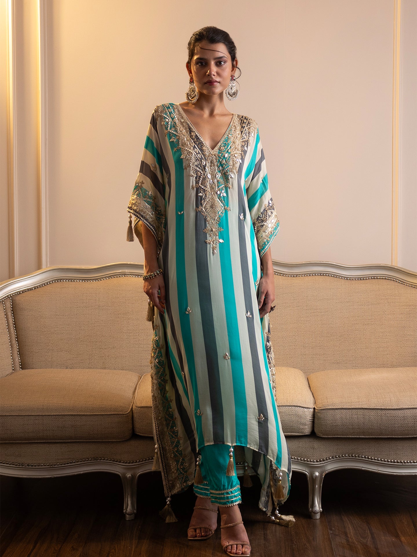 Step into elegance with this stunning kaftan and pant set! Featuring intricate gotta patti and mirror work