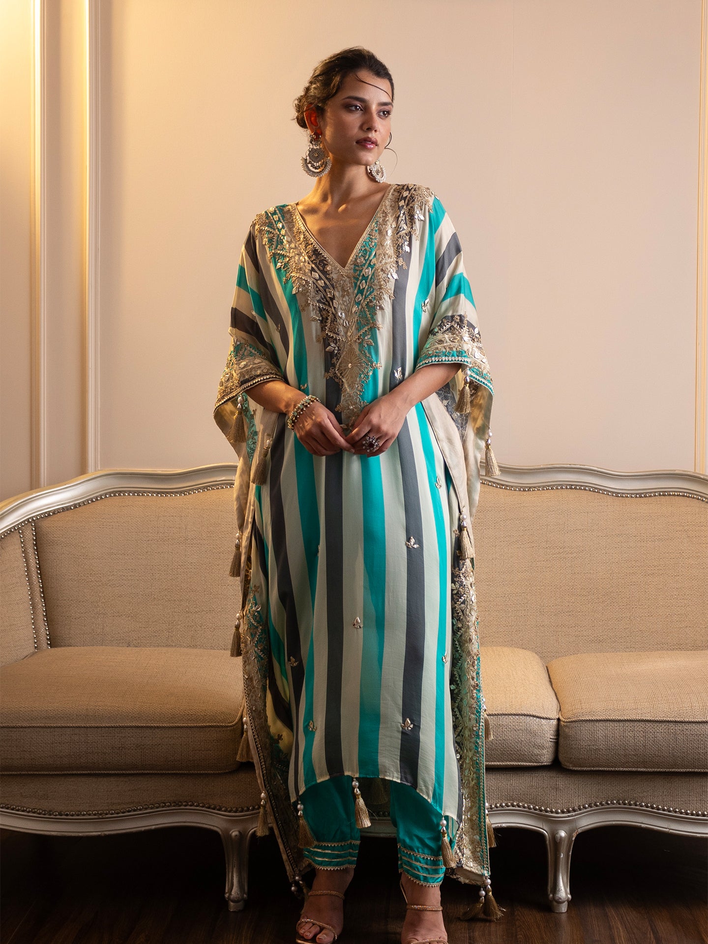 Step into elegance with this stunning kaftan and pant set! Featuring intricate gotta patti and mirror work