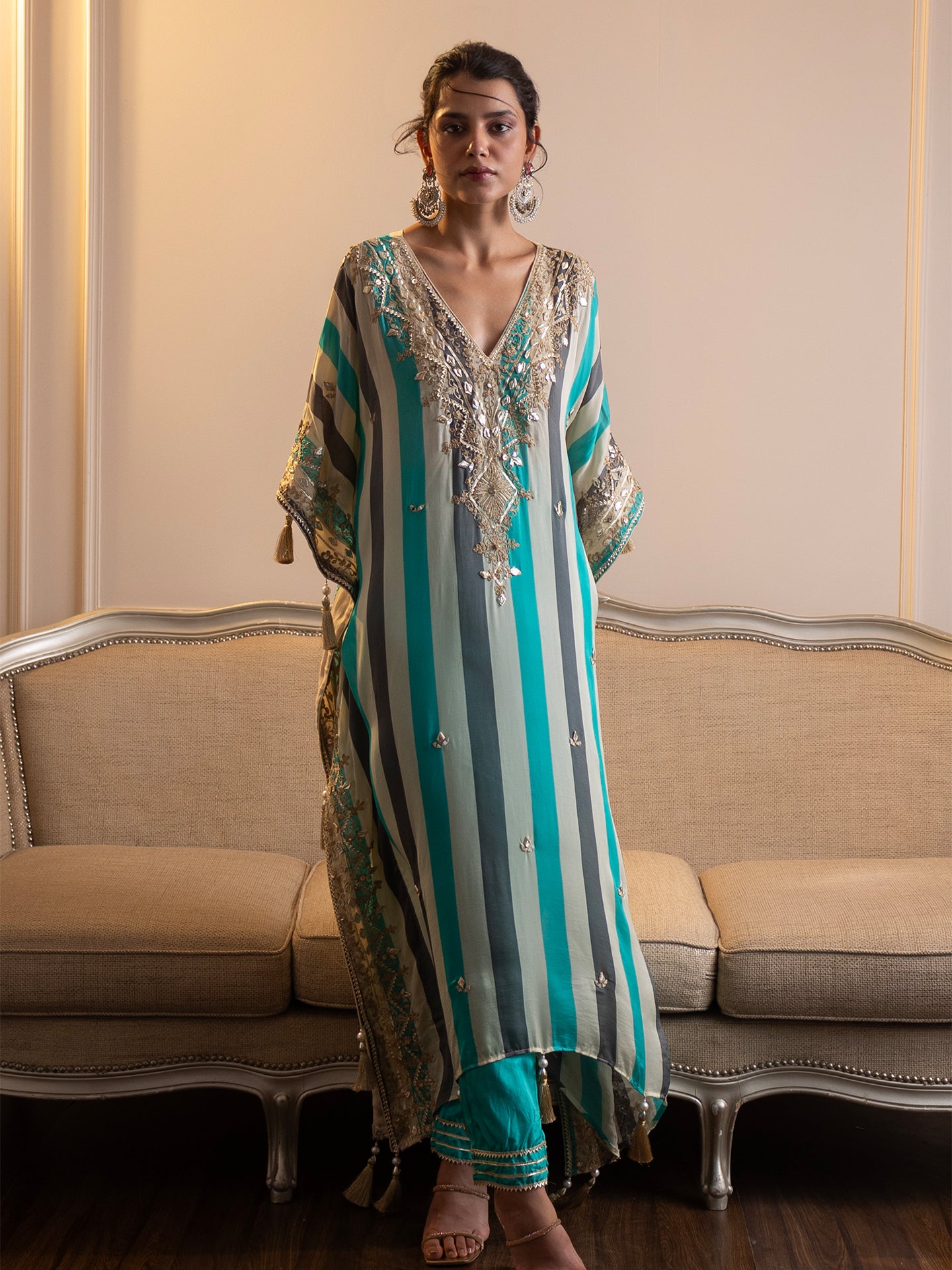 Step into elegance with this stunning kaftan and pant set! Featuring intricate gotta patti and mirror work