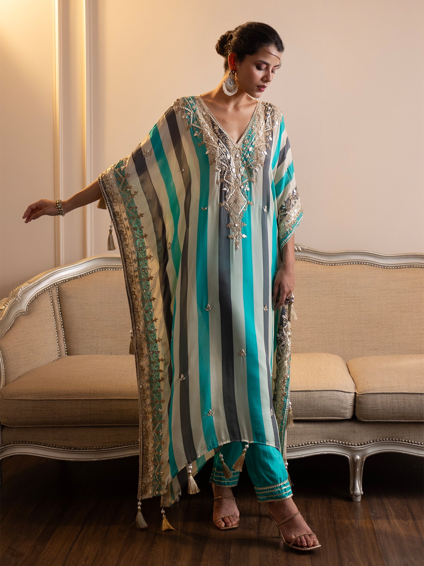 Step into elegance with this stunning kaftan and pant set! Featuring intricate gotta patti and mirror work