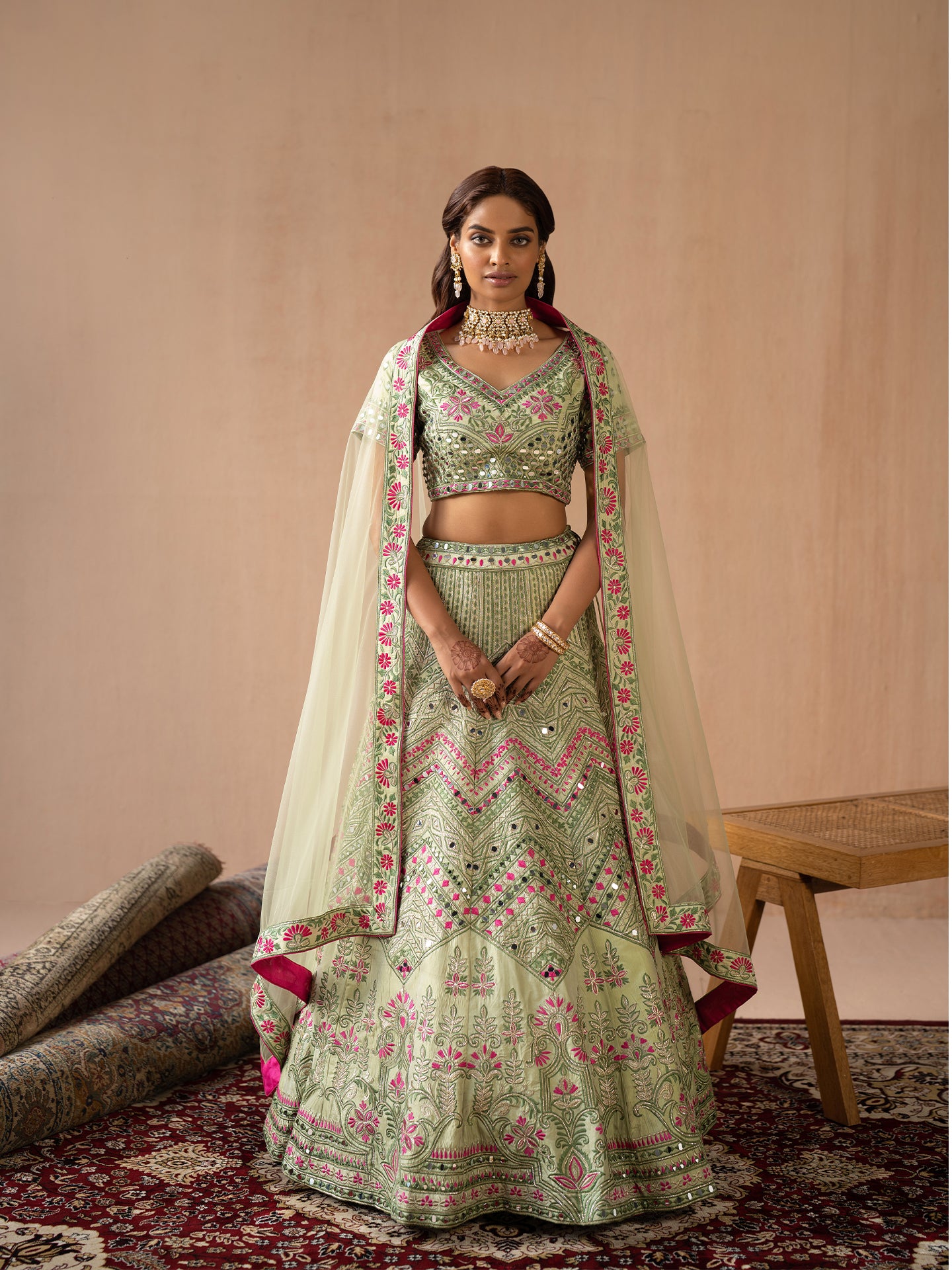 Mesmerising Pista green lehenga in silk with thread and mirror work.