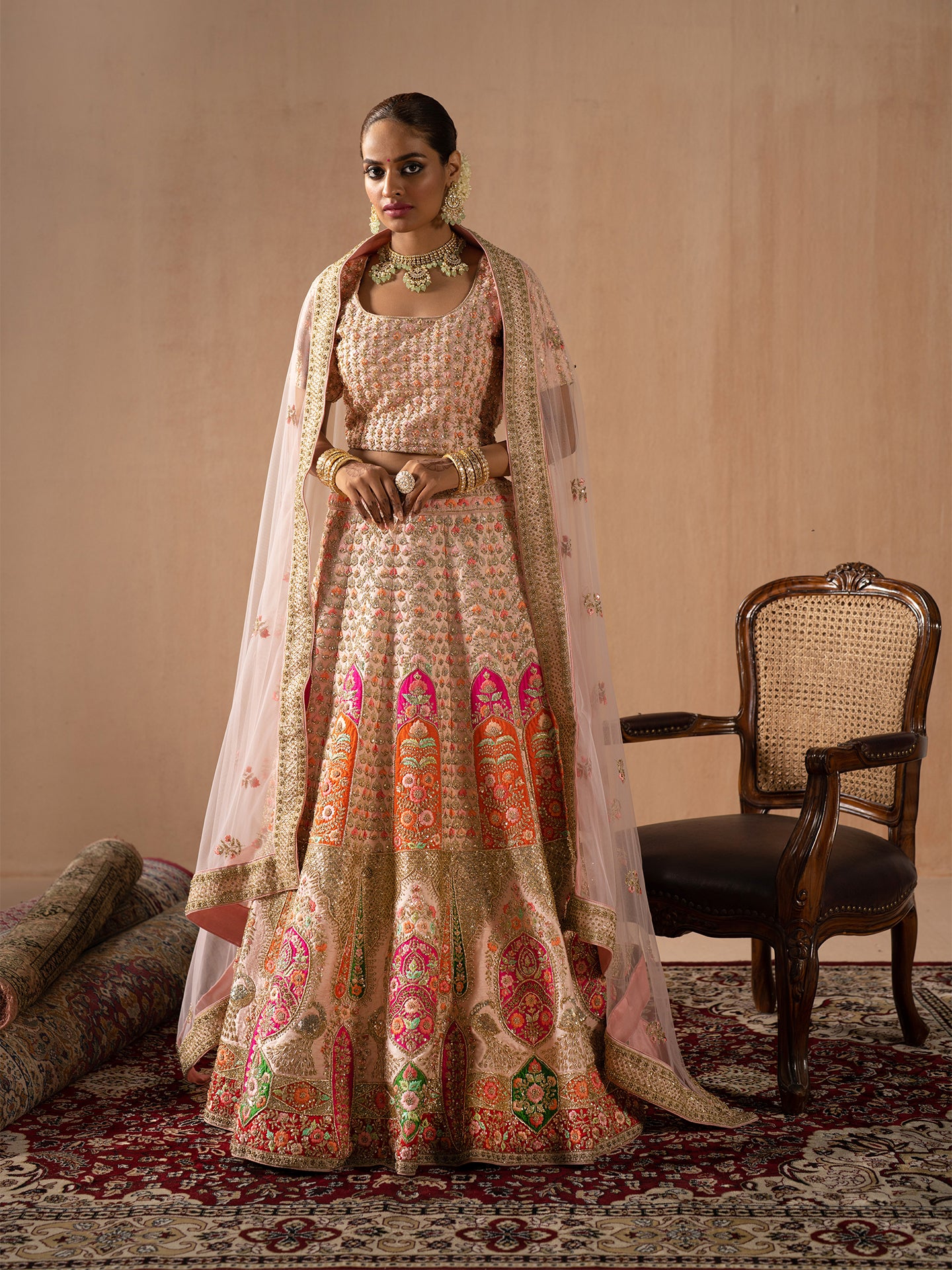 Navratan handwork lehenga in peach colour.