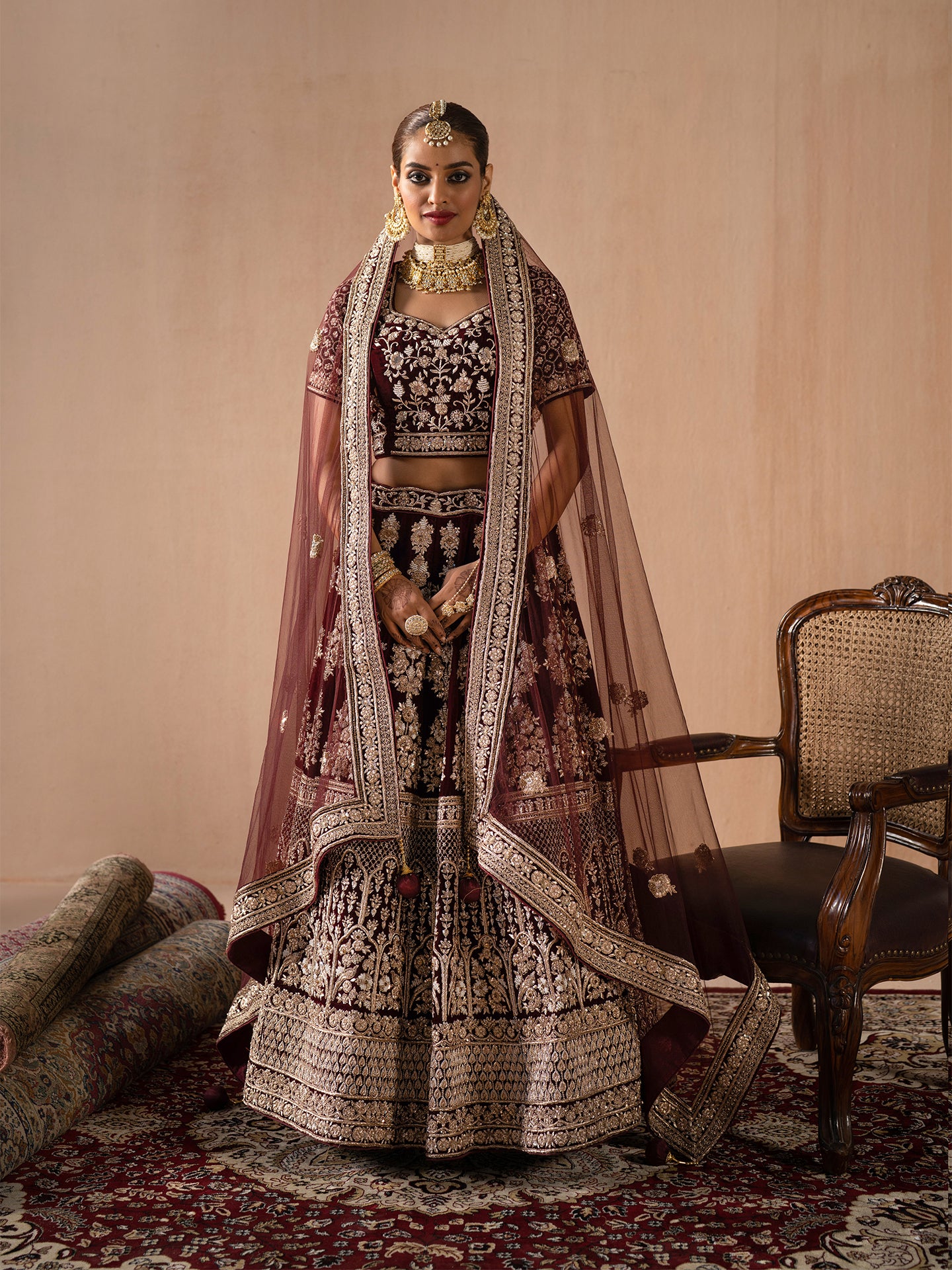 Luxurious maroon lehenga in silk with dabka work.