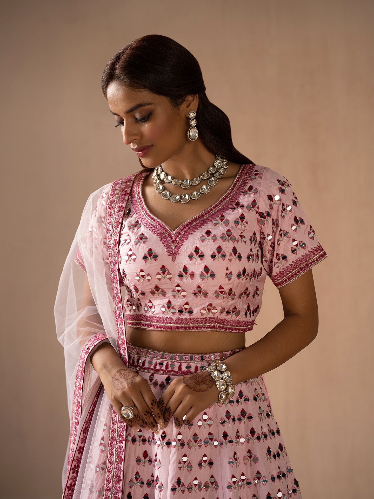 Alluring pink lehenga in silk with thread and mirror work.