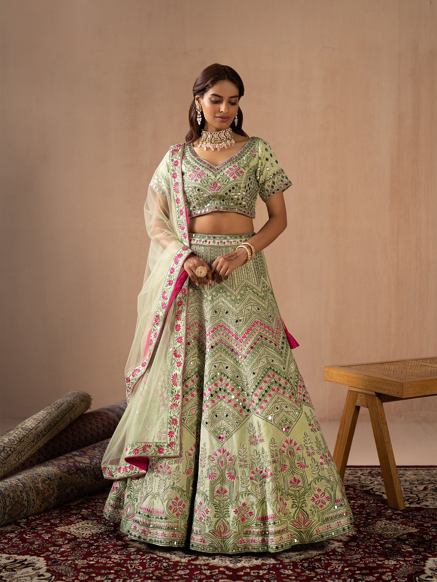 Mesmerising Pista green lehenga in silk with thread and mirror work.