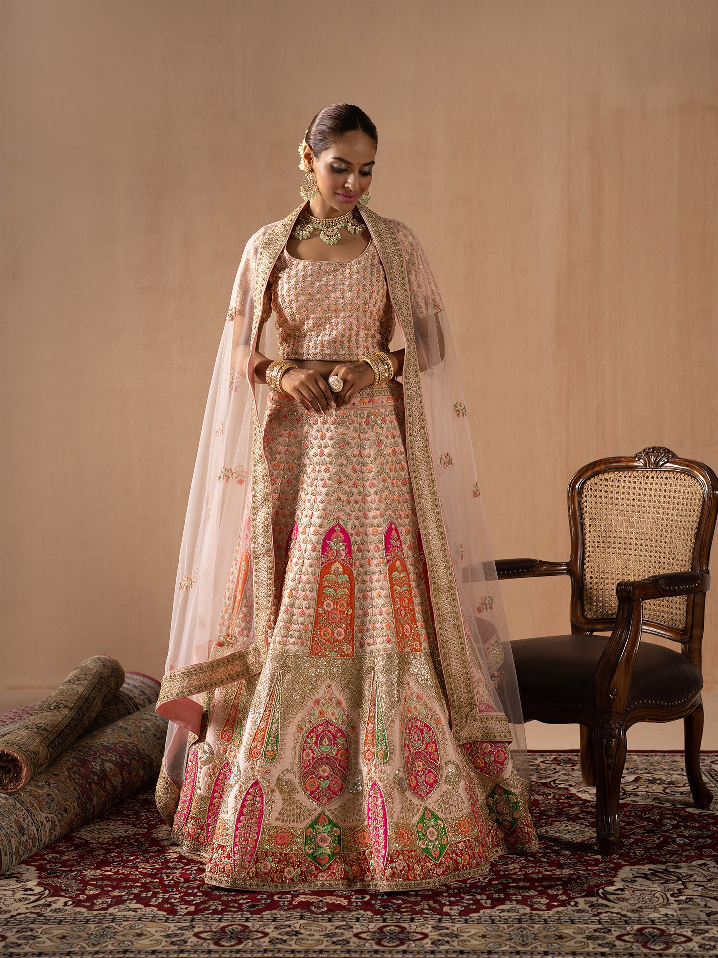 Navratan handwork lehenga in peach colour.