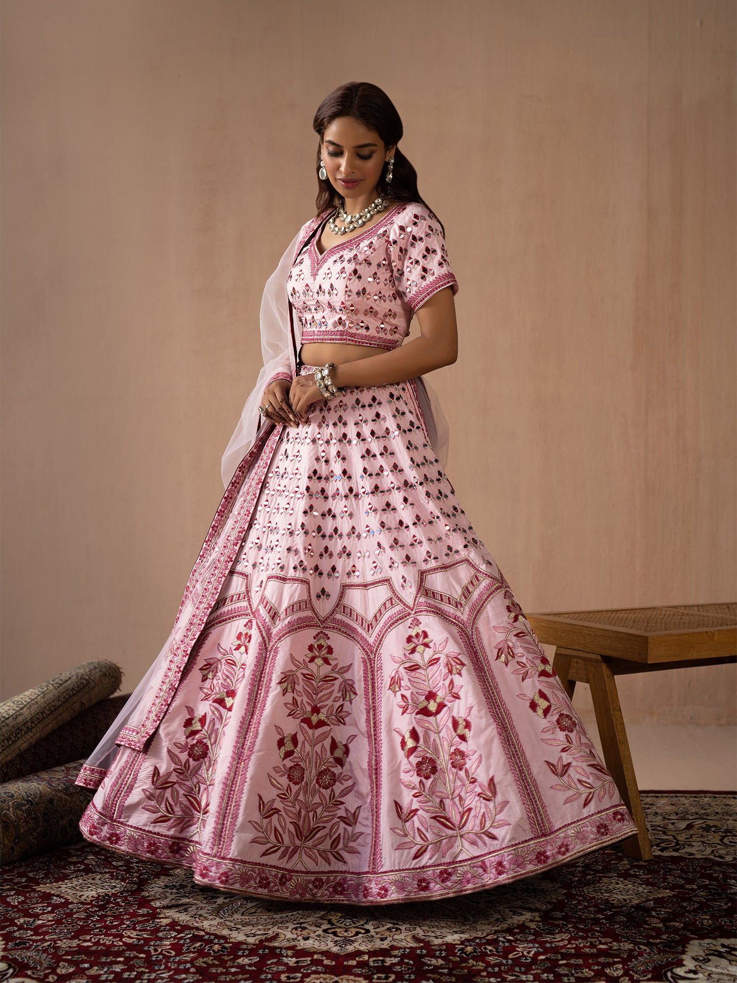 Alluring pink lehenga in silk with thread and mirror work.