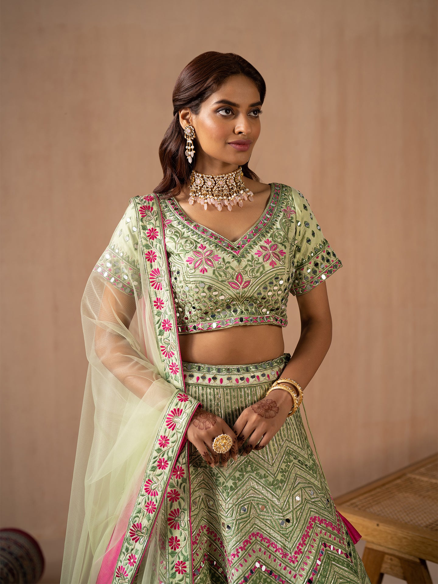 Mesmerising Pista green lehenga in silk with thread and mirror work.