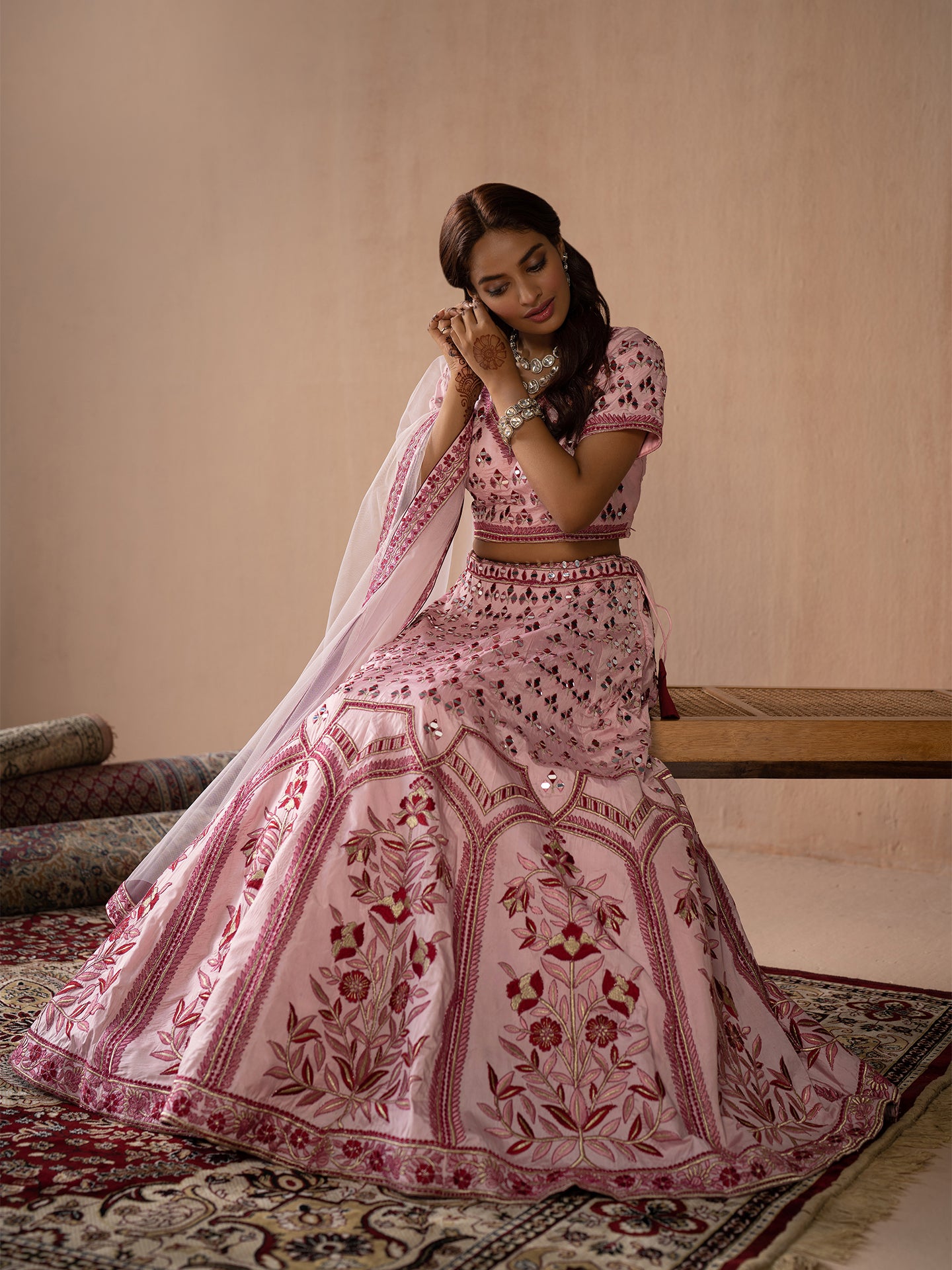 Alluring pink lehenga in silk with thread and mirror work.