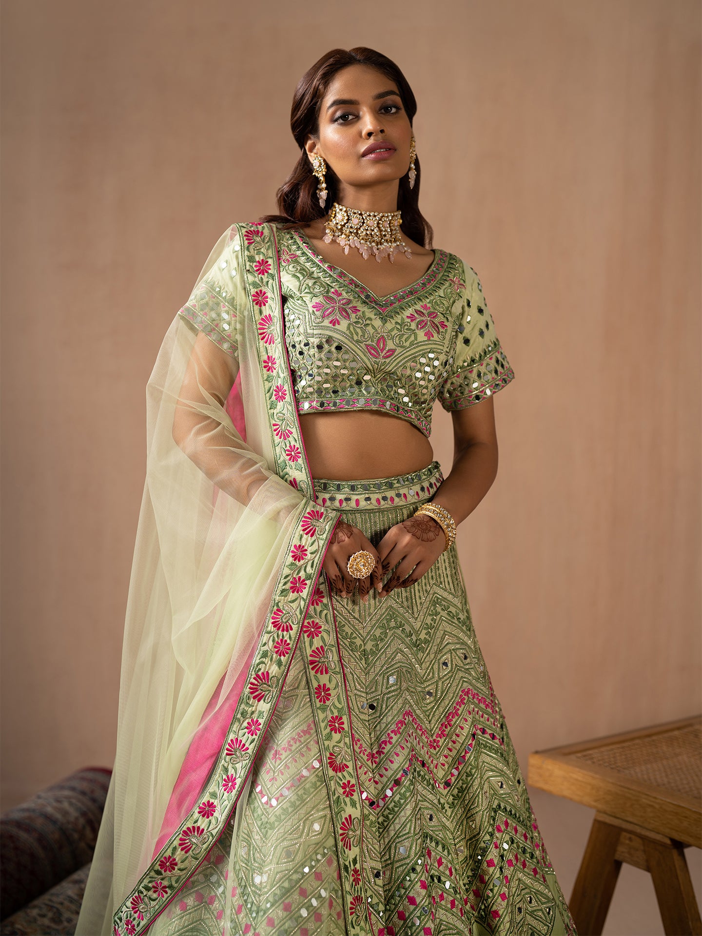 Mesmerising Pista green lehenga in silk with thread and mirror work.