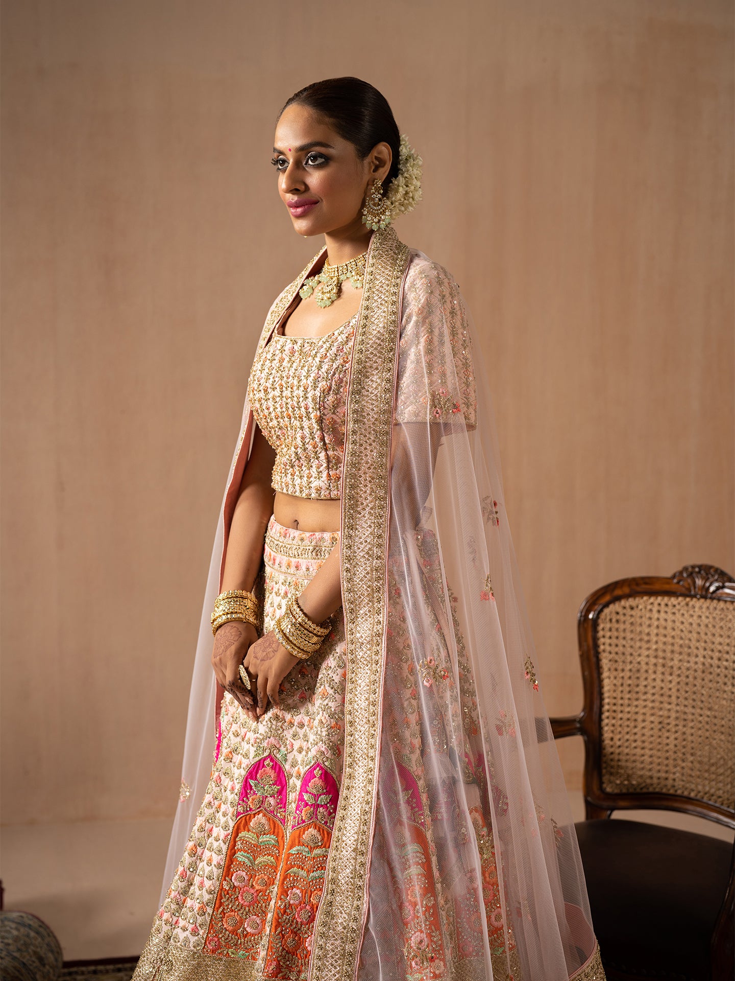 Navratan handwork lehenga in peach colour.