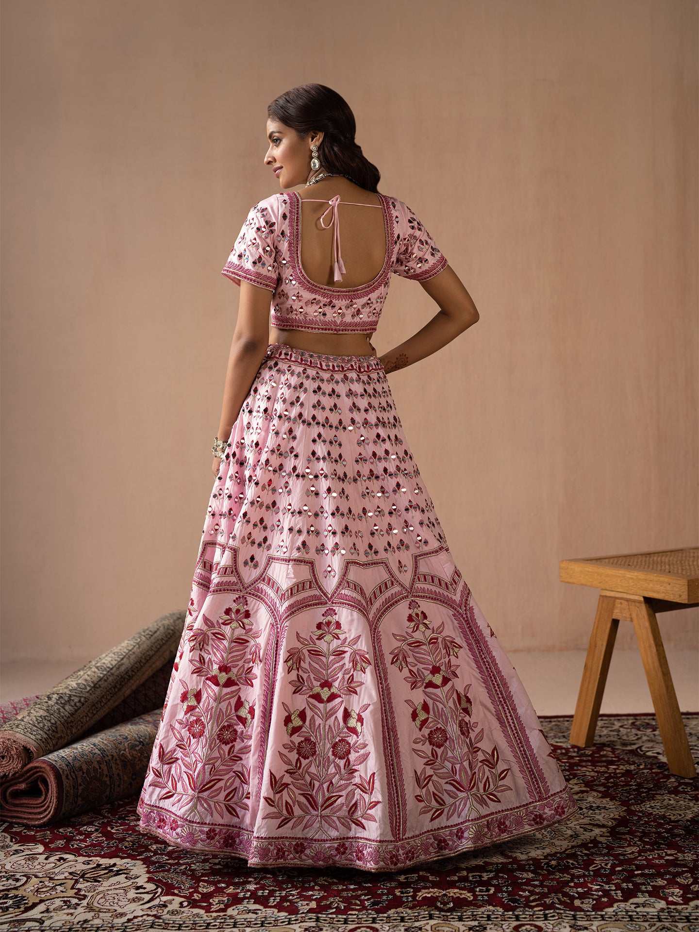 Alluring pink lehenga in silk with thread and mirror work.