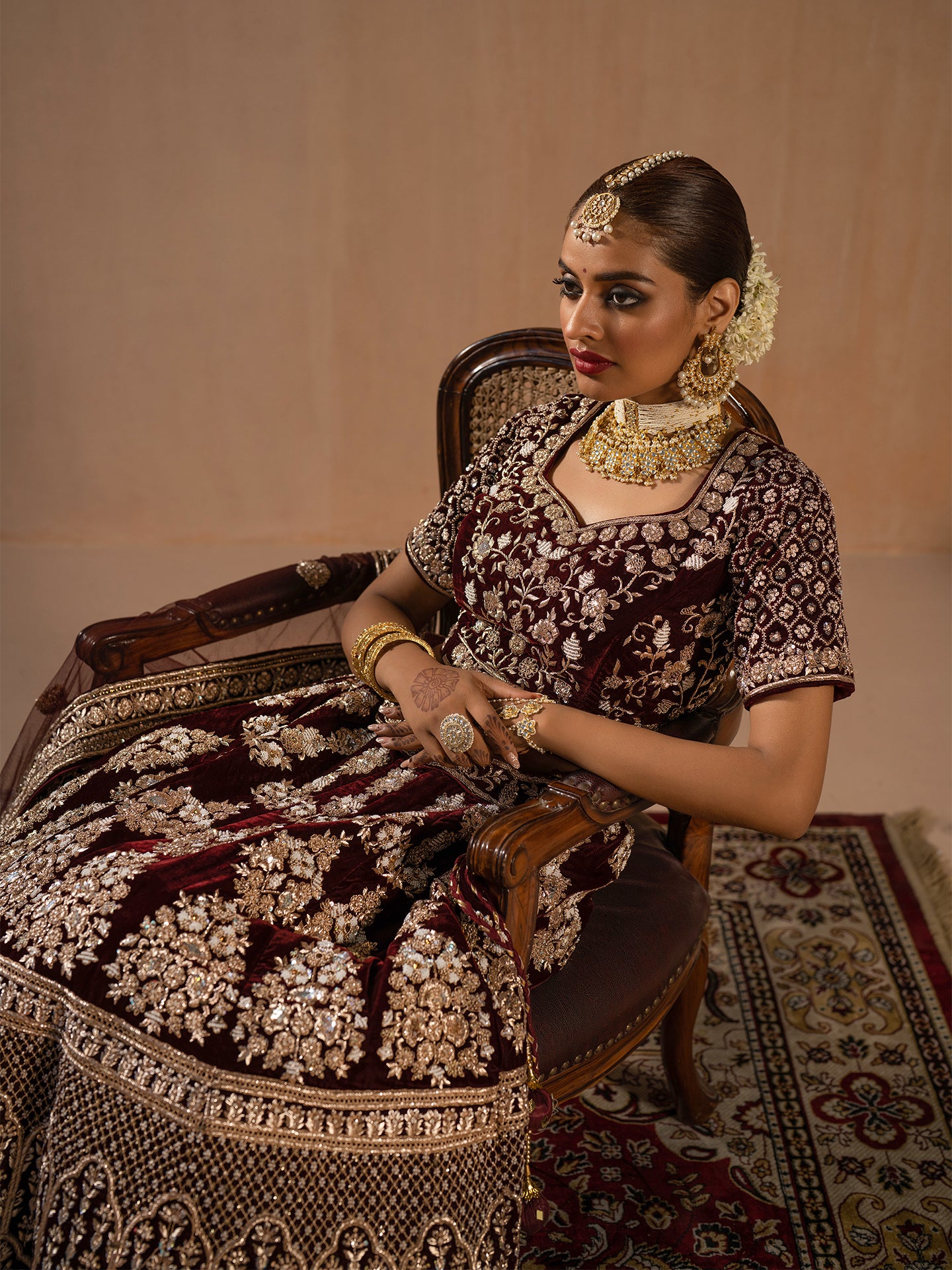 Luxurious maroon lehenga in silk with dabka work.