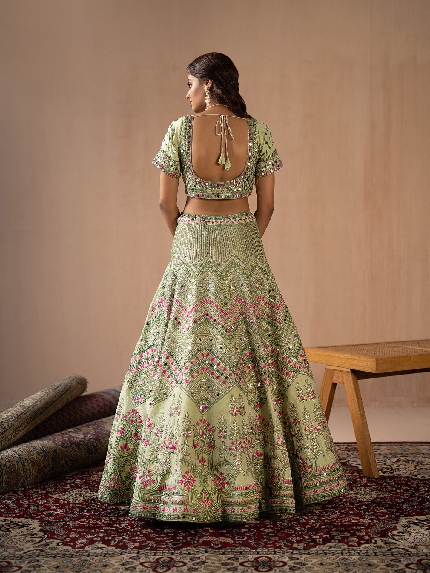 Mesmerising Pista green lehenga in silk with thread and mirror work.