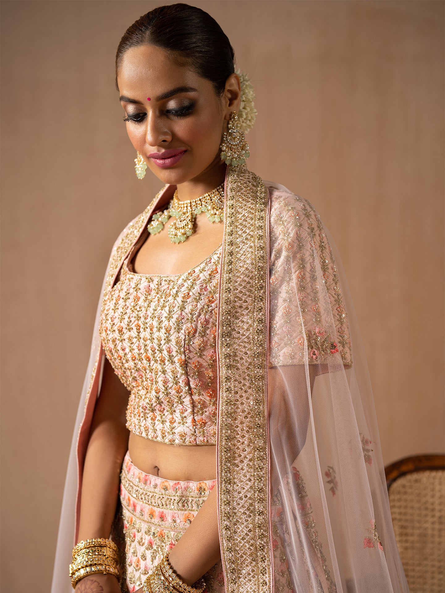 Navratan handwork lehenga in peach colour.