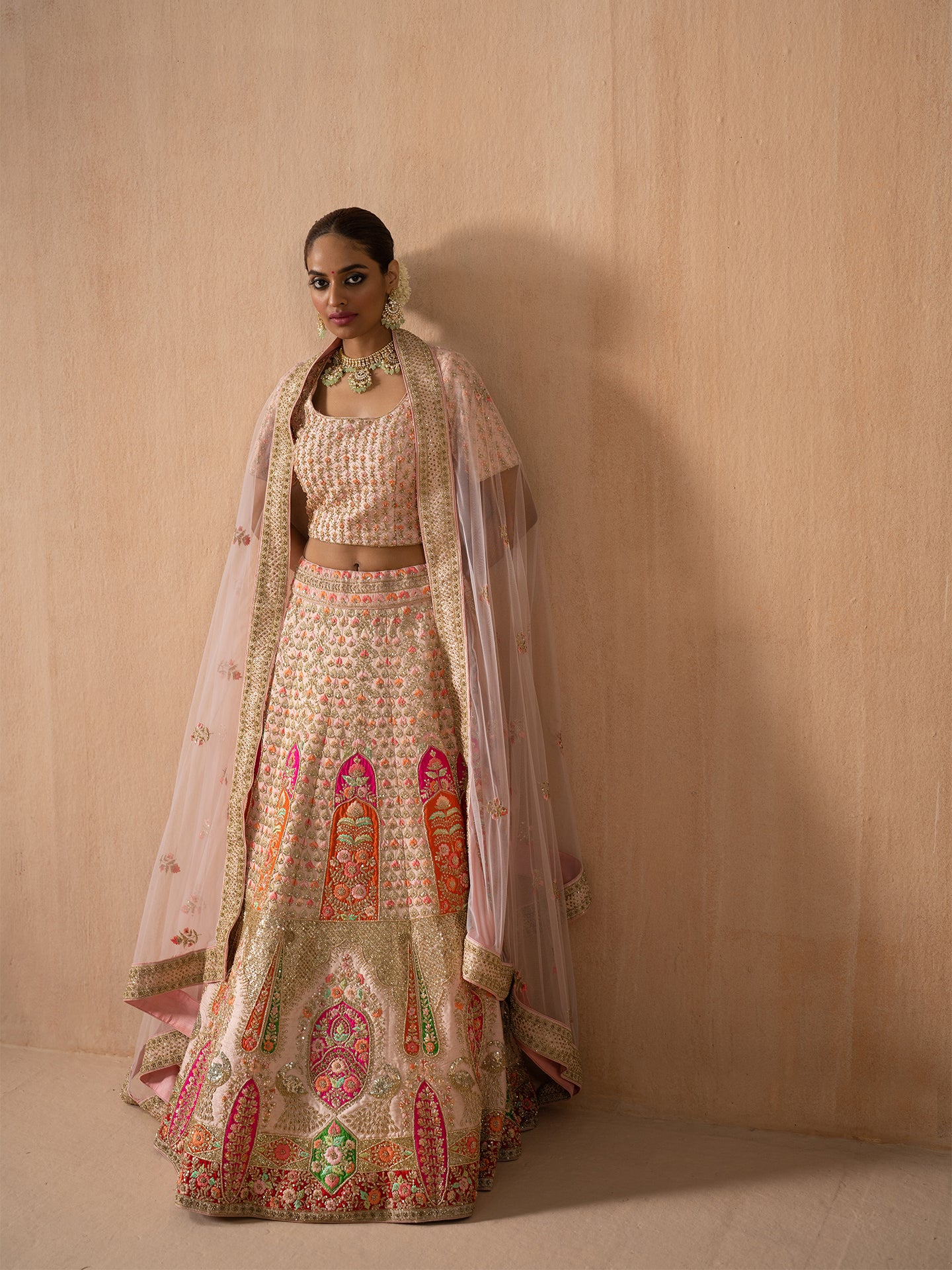 Navratan handwork lehenga in peach colour.