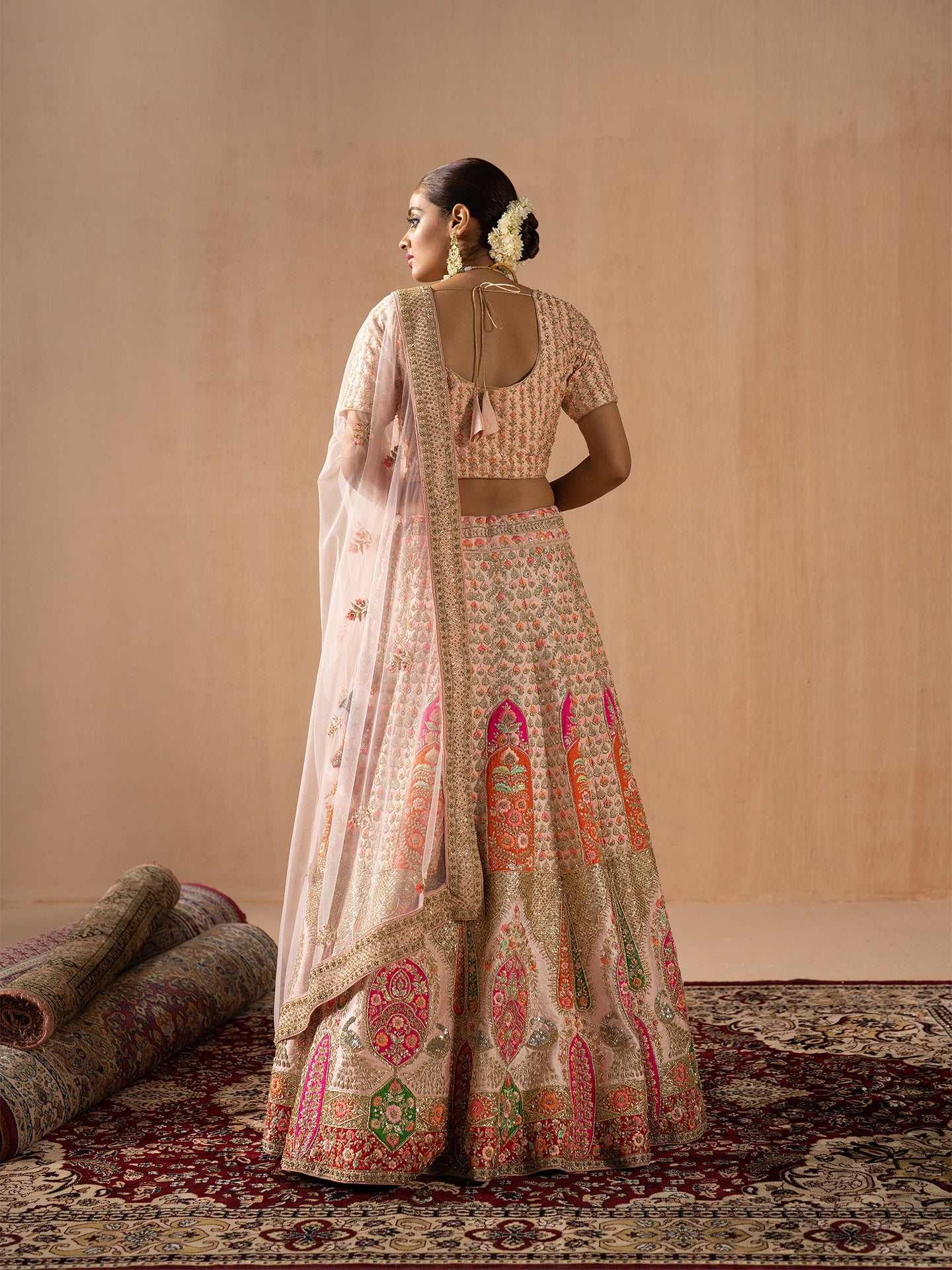 Navratan handwork lehenga in peach colour.